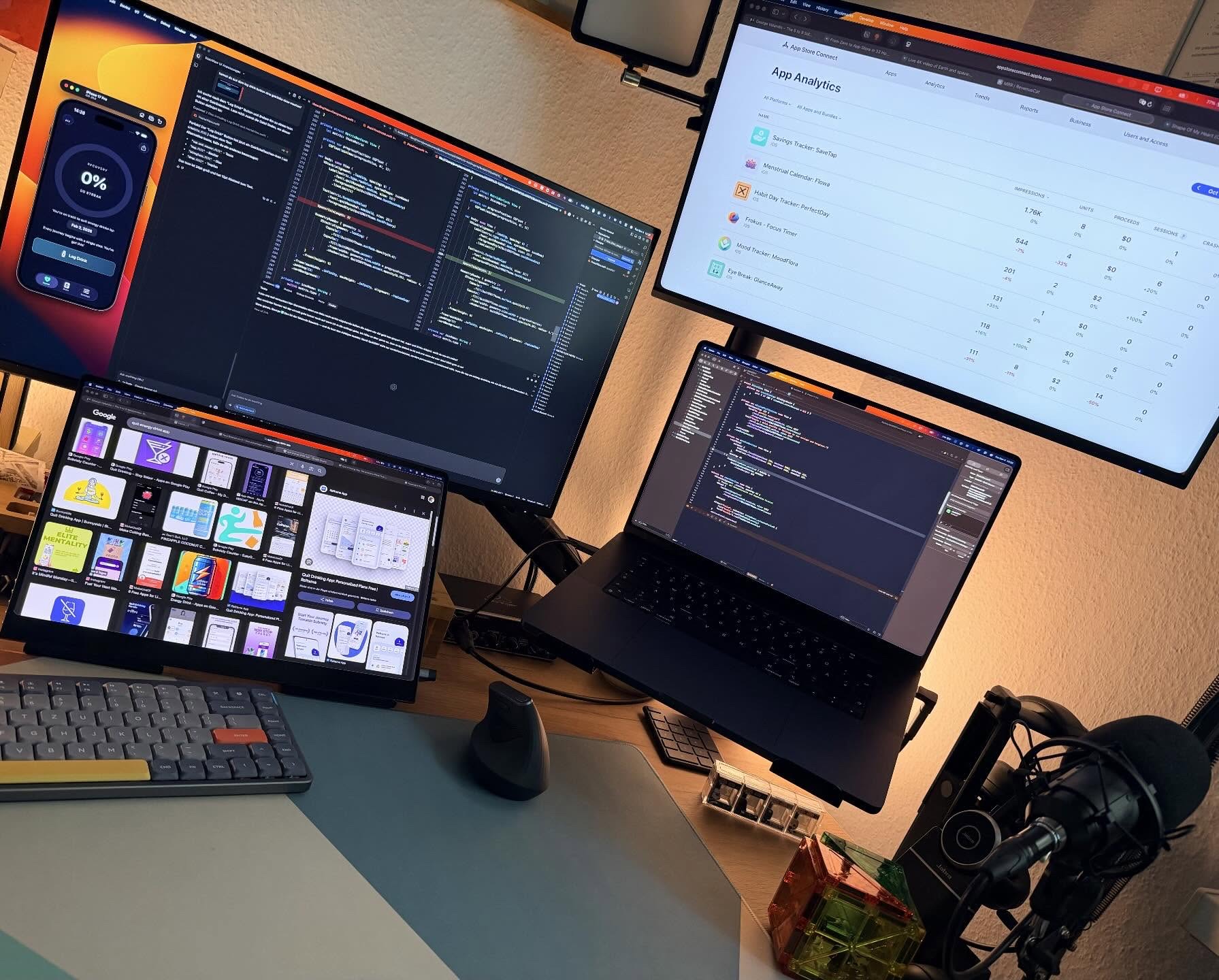 George Valandis desk setup with two monitors, a MacBook, keyboard and microphone